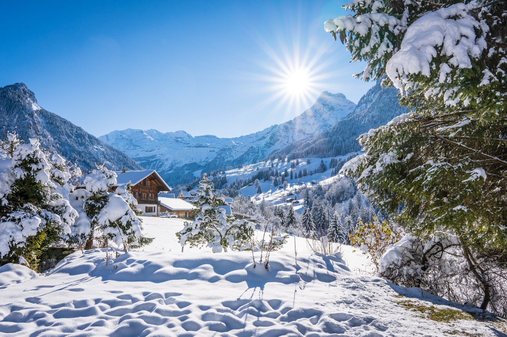 Verschneites Chalet im Kiental vor Bergen